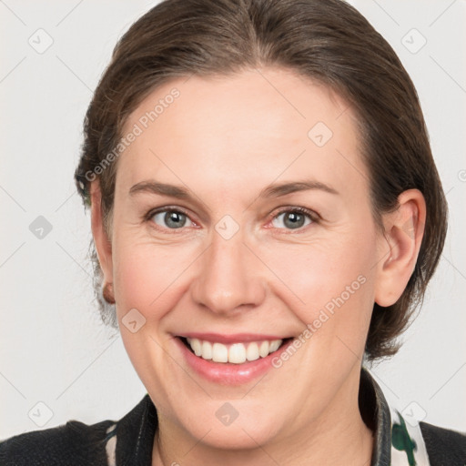 Joyful white adult female with medium  brown hair and grey eyes