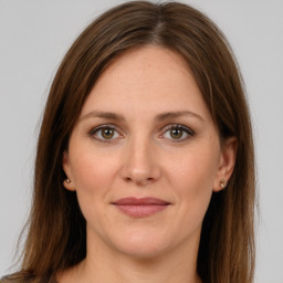 Joyful white young-adult female with long  brown hair and grey eyes