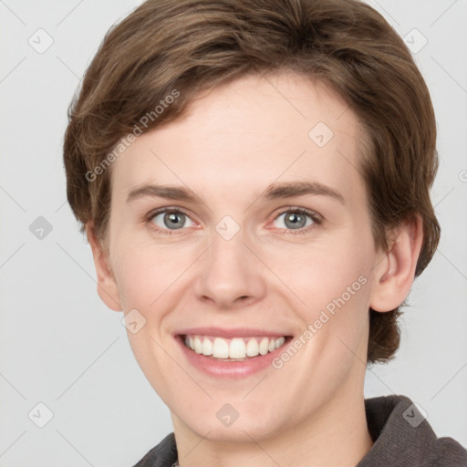 Joyful white young-adult female with short  brown hair and grey eyes