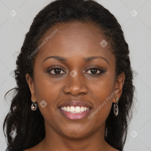 Joyful black young-adult female with long  brown hair and brown eyes