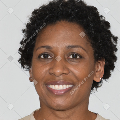 Joyful black adult female with short  brown hair and brown eyes