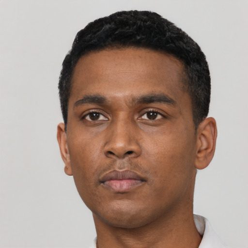 Neutral black young-adult male with short  black hair and brown eyes