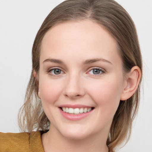 Joyful white young-adult female with medium  brown hair and blue eyes