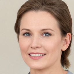 Joyful white young-adult female with medium  brown hair and grey eyes