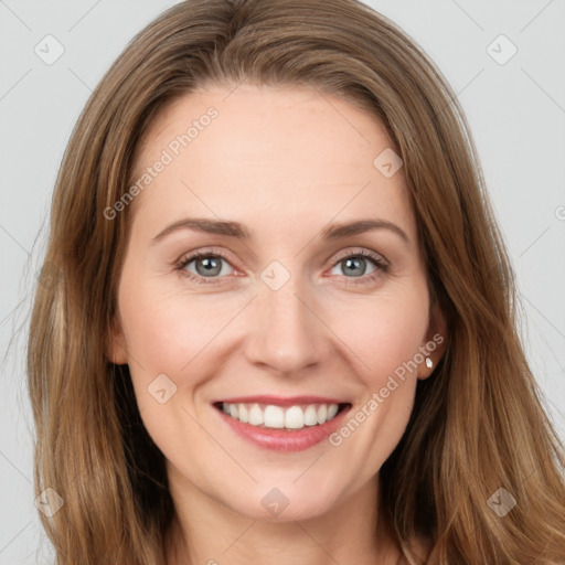 Joyful white young-adult female with long  brown hair and grey eyes