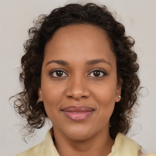 Joyful black young-adult female with medium  brown hair and brown eyes