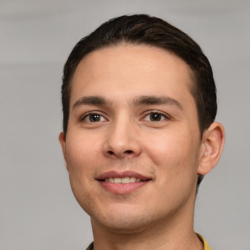 Joyful white young-adult male with short  brown hair and brown eyes