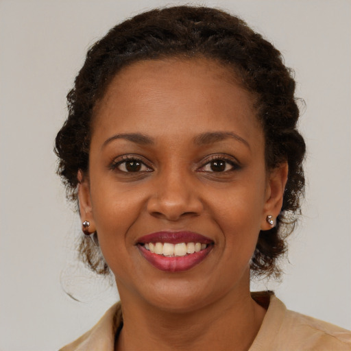 Joyful black young-adult female with medium  brown hair and brown eyes