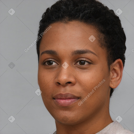 Joyful black young-adult female with short  black hair and brown eyes