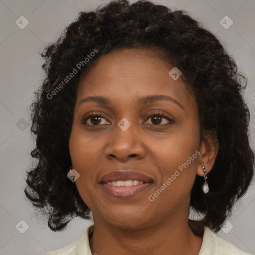 Joyful black adult female with medium  brown hair and brown eyes