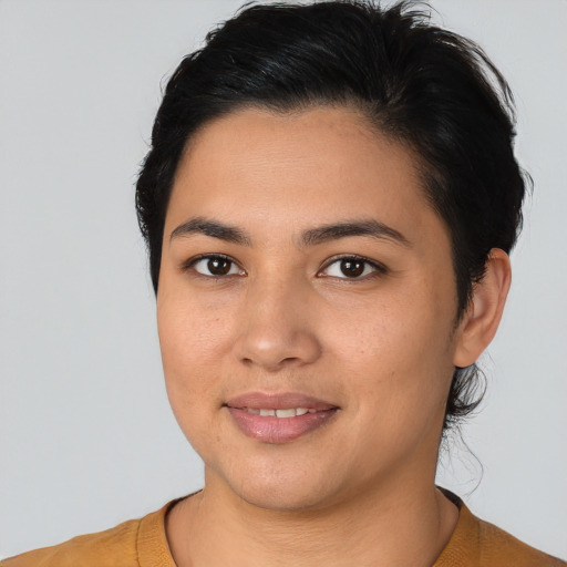 Joyful latino young-adult female with short  black hair and brown eyes