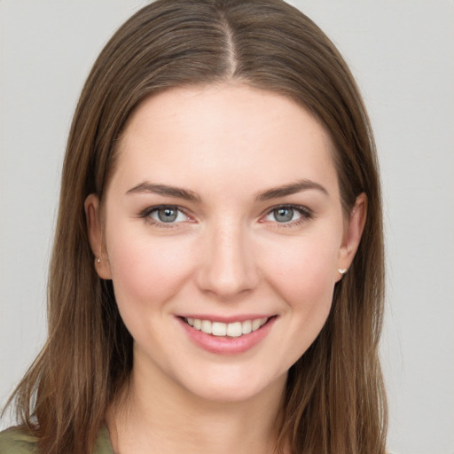 Joyful white young-adult female with long  brown hair and grey eyes