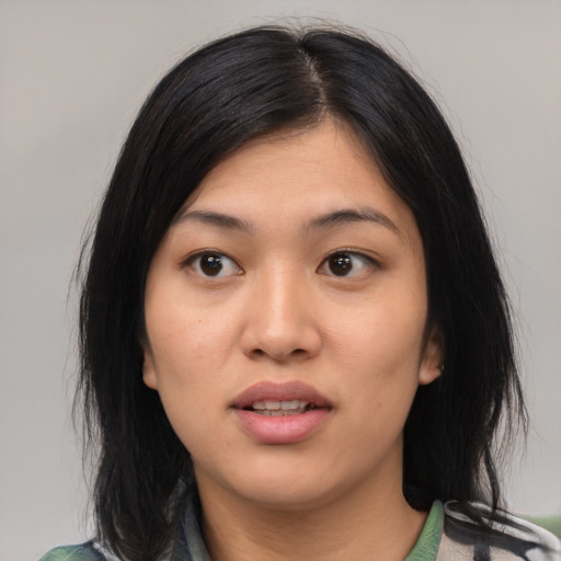 Joyful asian young-adult female with medium  black hair and brown eyes