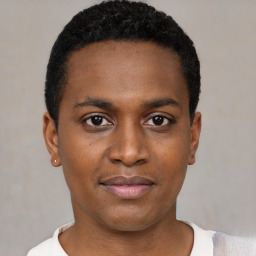 Joyful black young-adult male with short  black hair and brown eyes