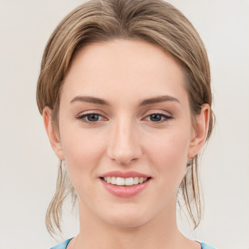 Joyful white young-adult female with medium  brown hair and blue eyes