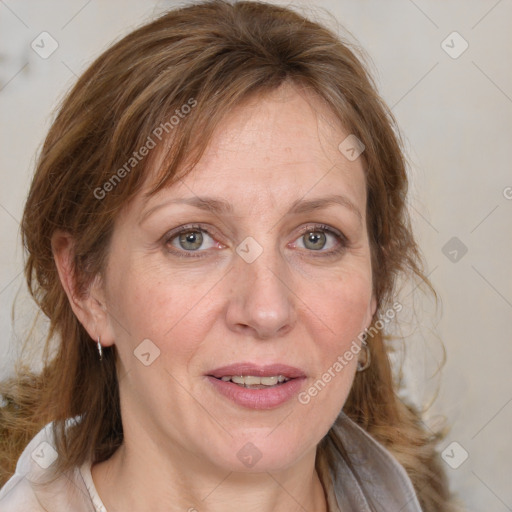 Joyful white adult female with medium  brown hair and blue eyes