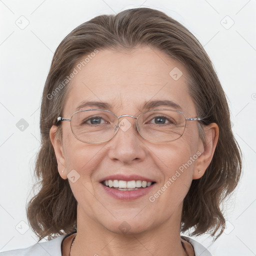 Joyful white adult female with medium  brown hair and grey eyes