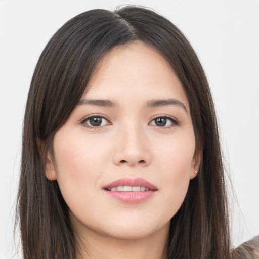 Joyful asian young-adult female with long  brown hair and brown eyes