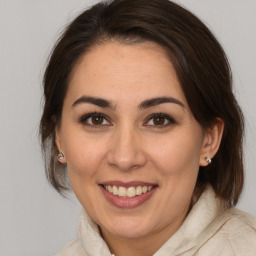 Joyful white adult female with medium  brown hair and brown eyes