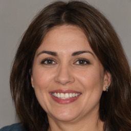 Joyful white adult female with medium  brown hair and brown eyes