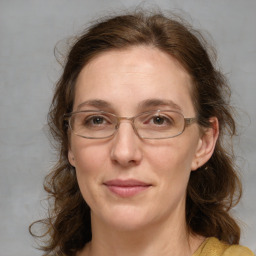 Joyful white adult female with medium  brown hair and grey eyes