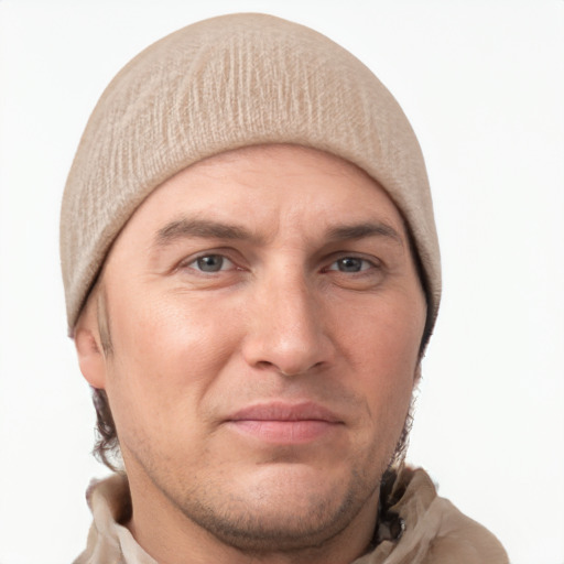 Joyful white adult male with short  brown hair and grey eyes