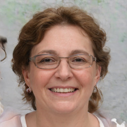 Joyful white adult female with medium  brown hair and blue eyes