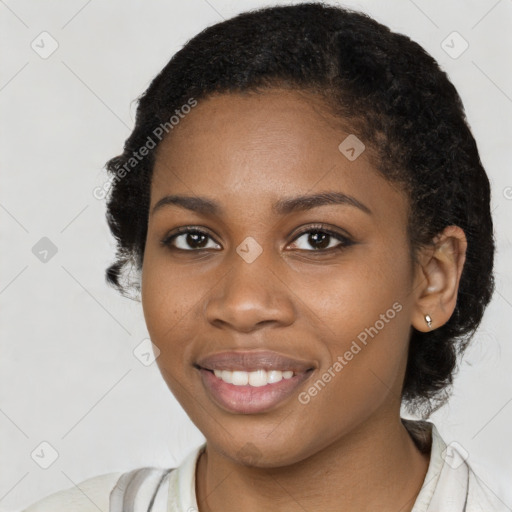 Joyful black young-adult female with medium  black hair and brown eyes