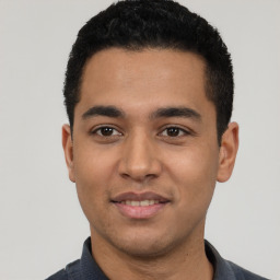 Joyful latino young-adult male with short  black hair and brown eyes