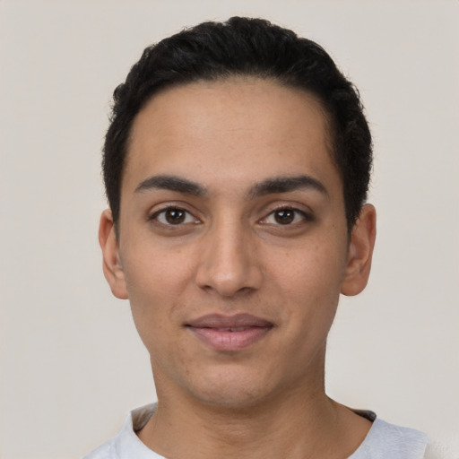 Joyful latino young-adult male with short  black hair and brown eyes