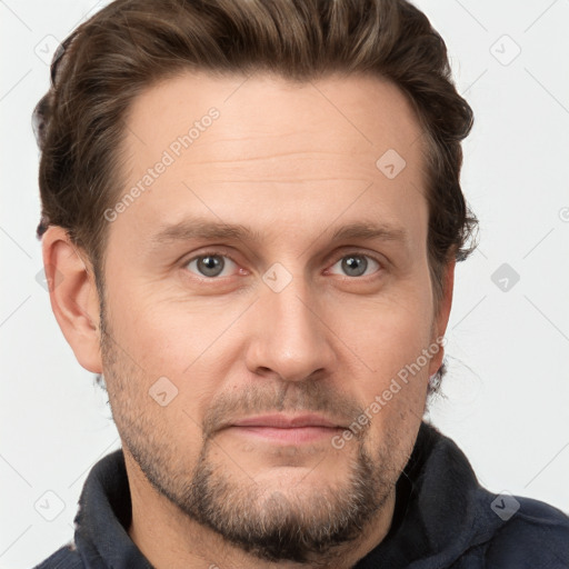 Joyful white adult male with short  brown hair and grey eyes