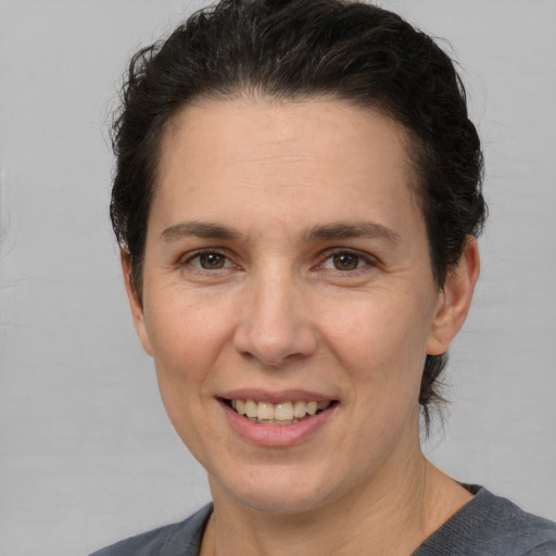 Joyful white adult female with short  brown hair and brown eyes