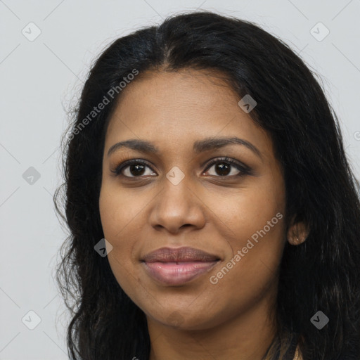 Joyful black young-adult female with long  black hair and brown eyes