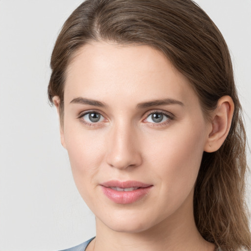 Joyful white young-adult female with long  brown hair and grey eyes