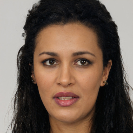 Joyful latino young-adult female with long  black hair and brown eyes