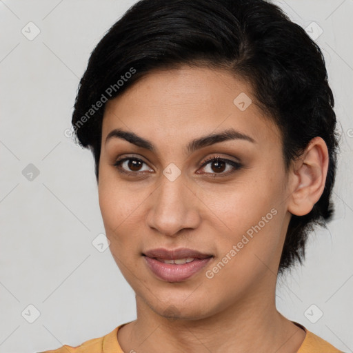 Joyful latino young-adult female with short  brown hair and brown eyes