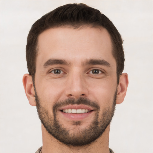 Joyful white young-adult male with short  brown hair and brown eyes