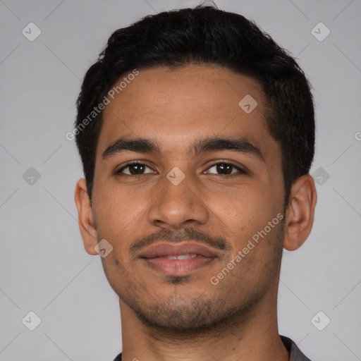 Joyful latino young-adult male with short  brown hair and brown eyes