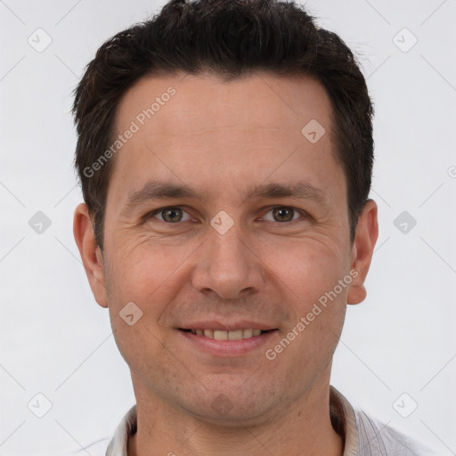 Joyful white adult male with short  brown hair and brown eyes
