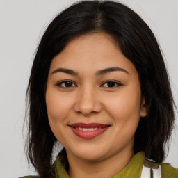 Joyful latino young-adult female with medium  brown hair and brown eyes