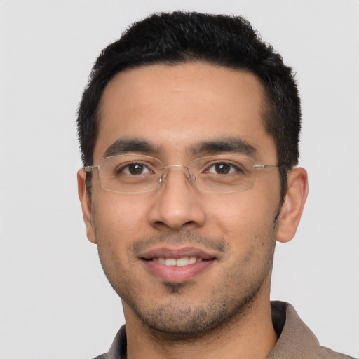 Joyful white young-adult male with short  black hair and brown eyes