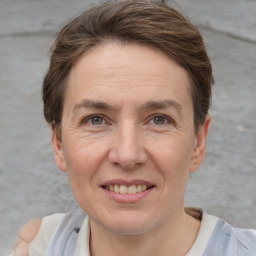 Joyful white adult female with short  brown hair and grey eyes