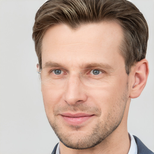 Joyful white adult male with short  brown hair and grey eyes