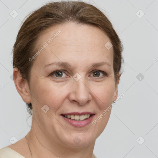 Joyful white adult female with short  brown hair and grey eyes