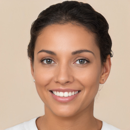 Joyful white young-adult female with short  brown hair and brown eyes