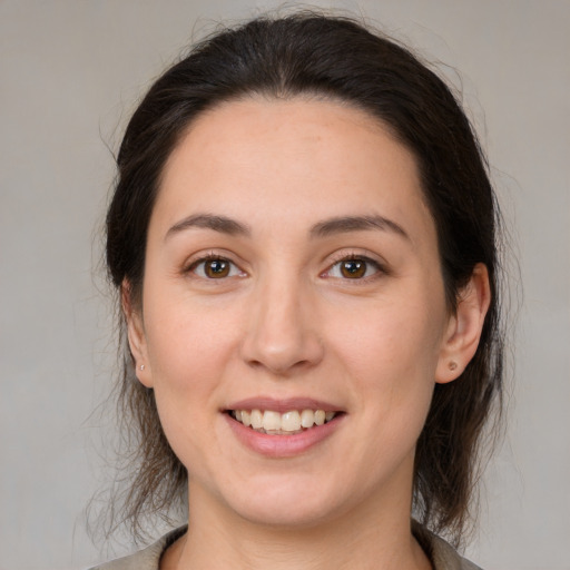 Joyful white young-adult female with medium  brown hair and brown eyes