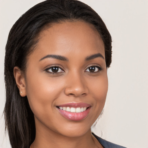 Joyful latino young-adult female with long  brown hair and brown eyes