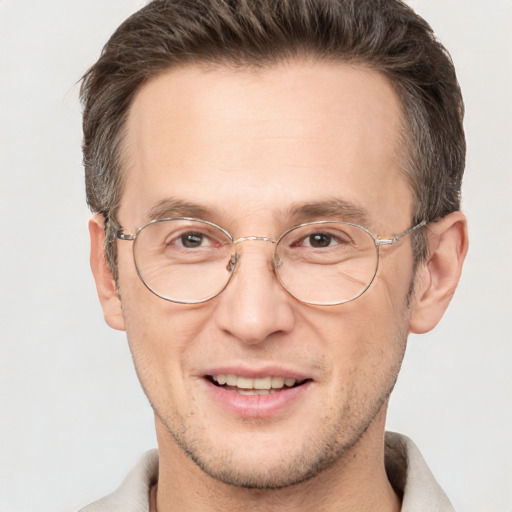 Joyful white adult male with short  brown hair and brown eyes