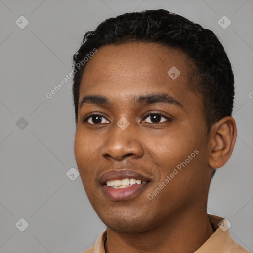 Joyful black young-adult male with short  black hair and brown eyes