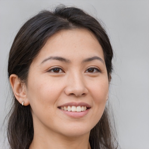 Joyful white young-adult female with long  brown hair and brown eyes